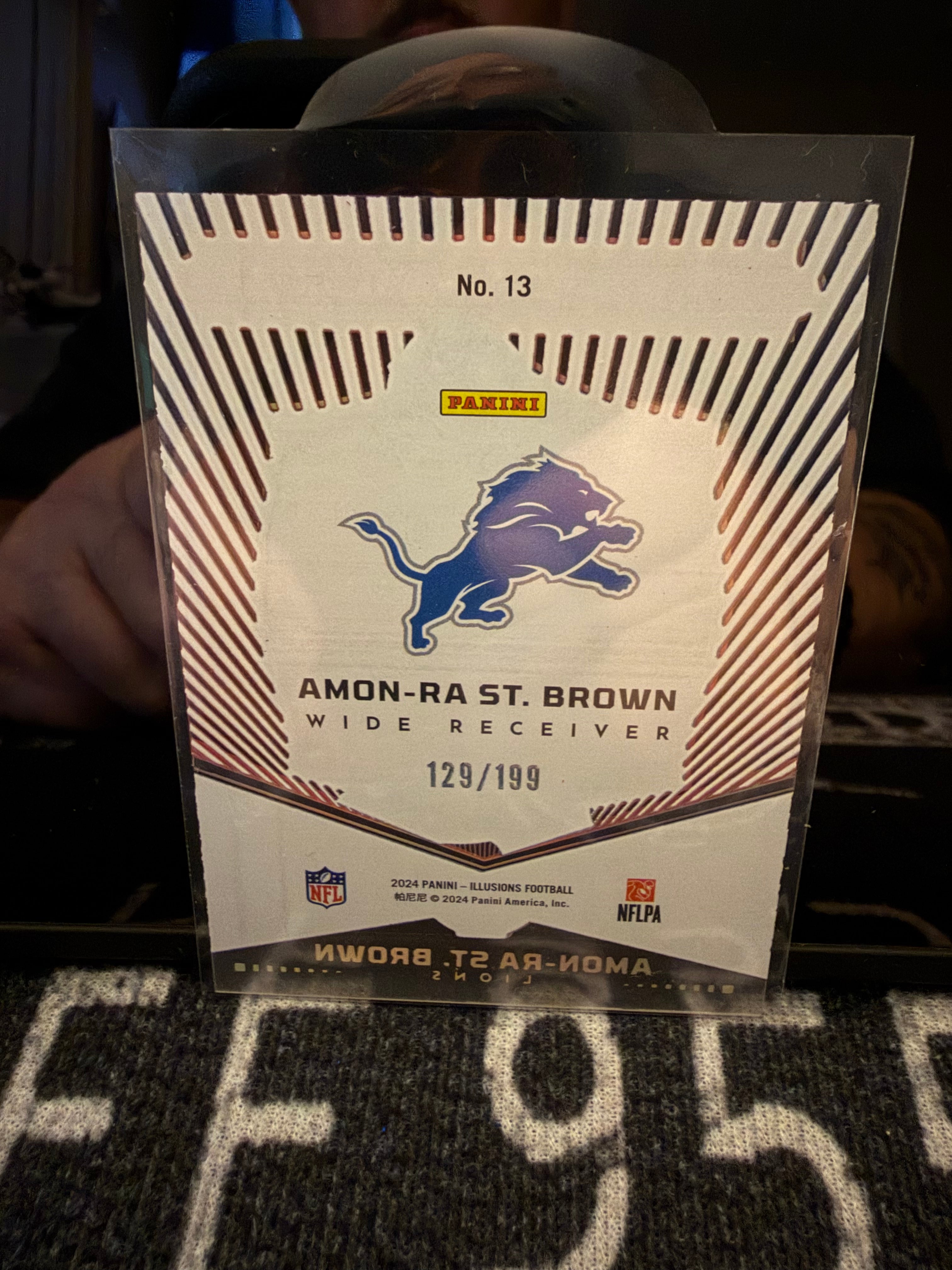 Amon-Ra St. Brown 2024 Panini Illusions Abracadabra Acetate /199 Lions #121/199