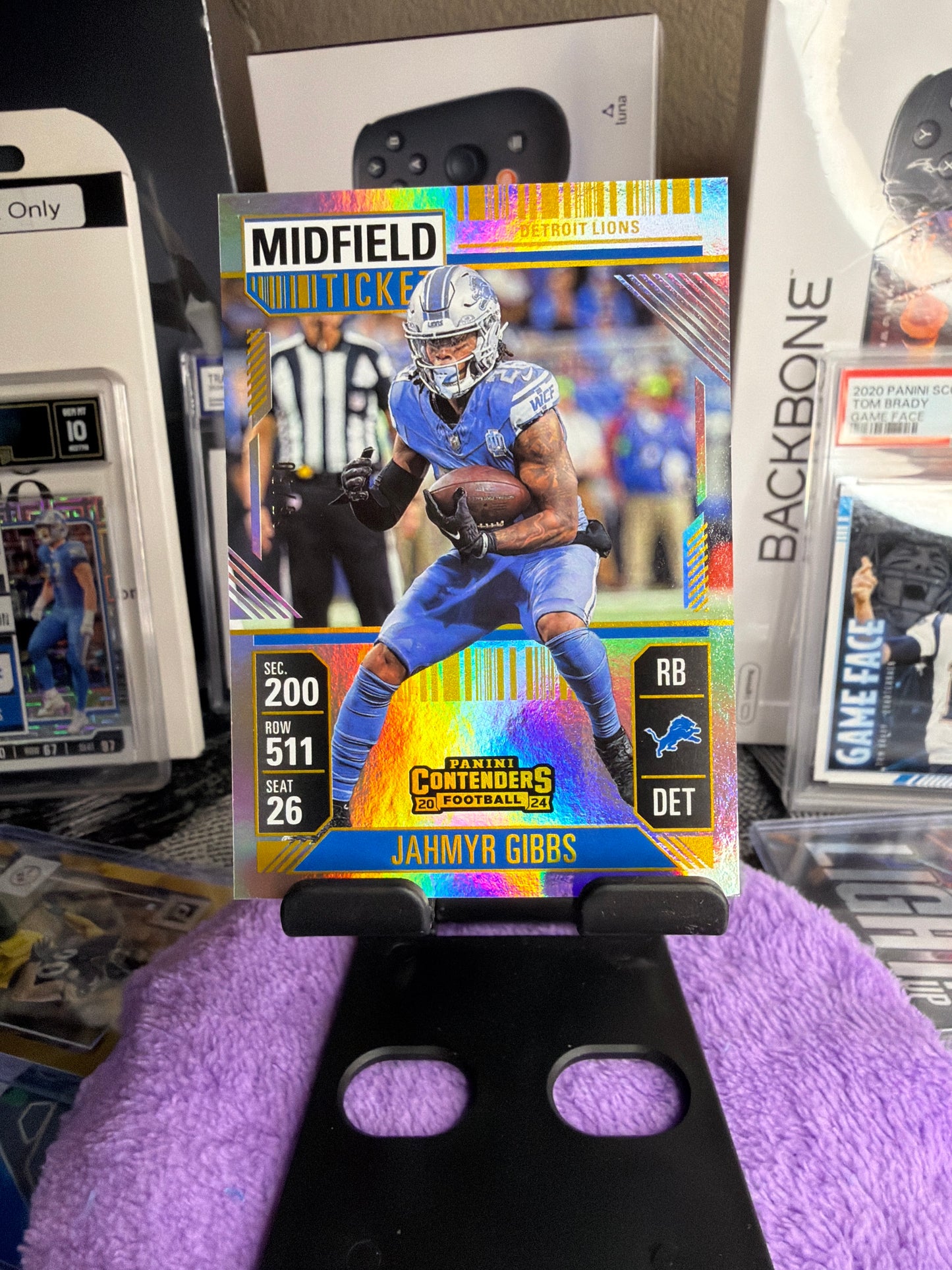 Jahmyr Gibbs 3-Card Numbered Lot – 05/50 Midfield Ticket + 24/49 Revolution Gold Fireworks + 087/549 Revolution Cosmic