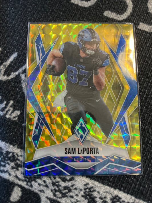 2025 Panini Phoenix Football Sam LaPorta – Yellow Pyramids parallel, serial numbered 004/185 (Card #44).